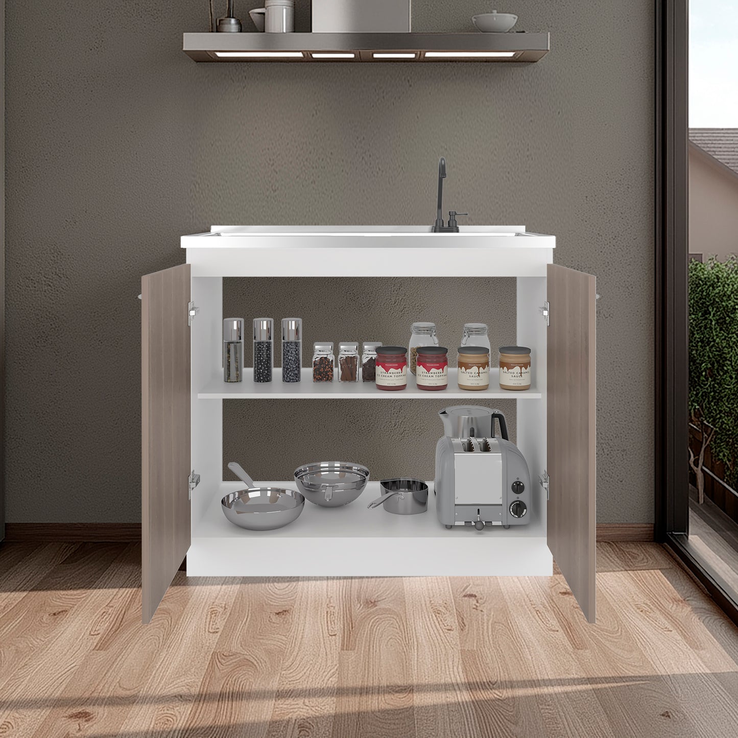 White kitchen cabinet with open doors displaying various kitchen items on a wooden floor.