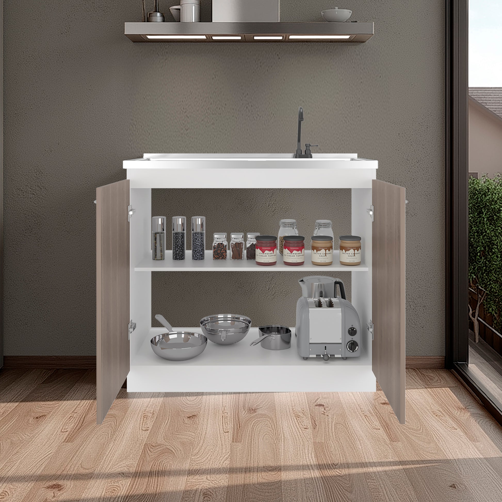 White kitchen cabinet with open doors displaying various kitchen items on a wooden floor.