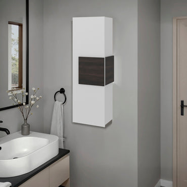 Bathroom with a white cabinet on a gray wall, sink, and mirror.