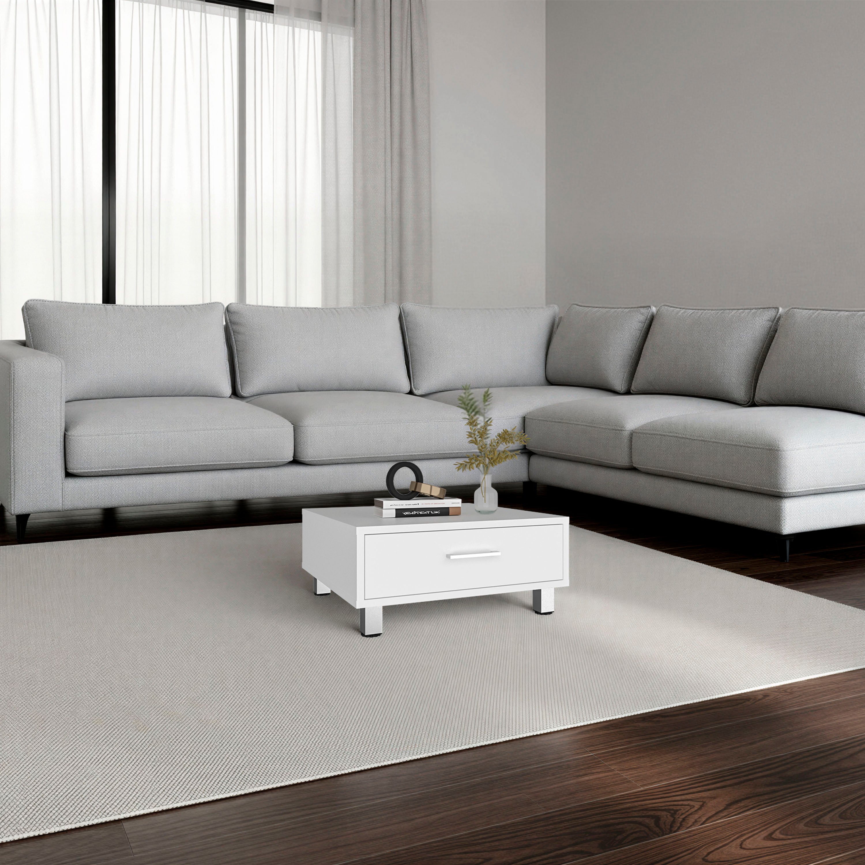 Gray sectional sofa in a modern living room with a white coffee table.